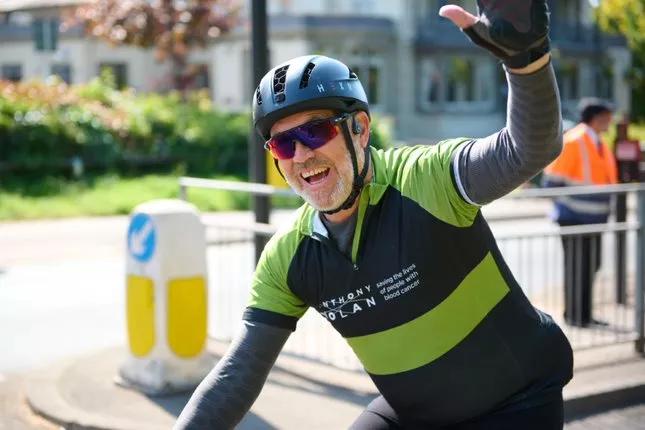 Man smiling whilst on his bike and completing the RideLondon 