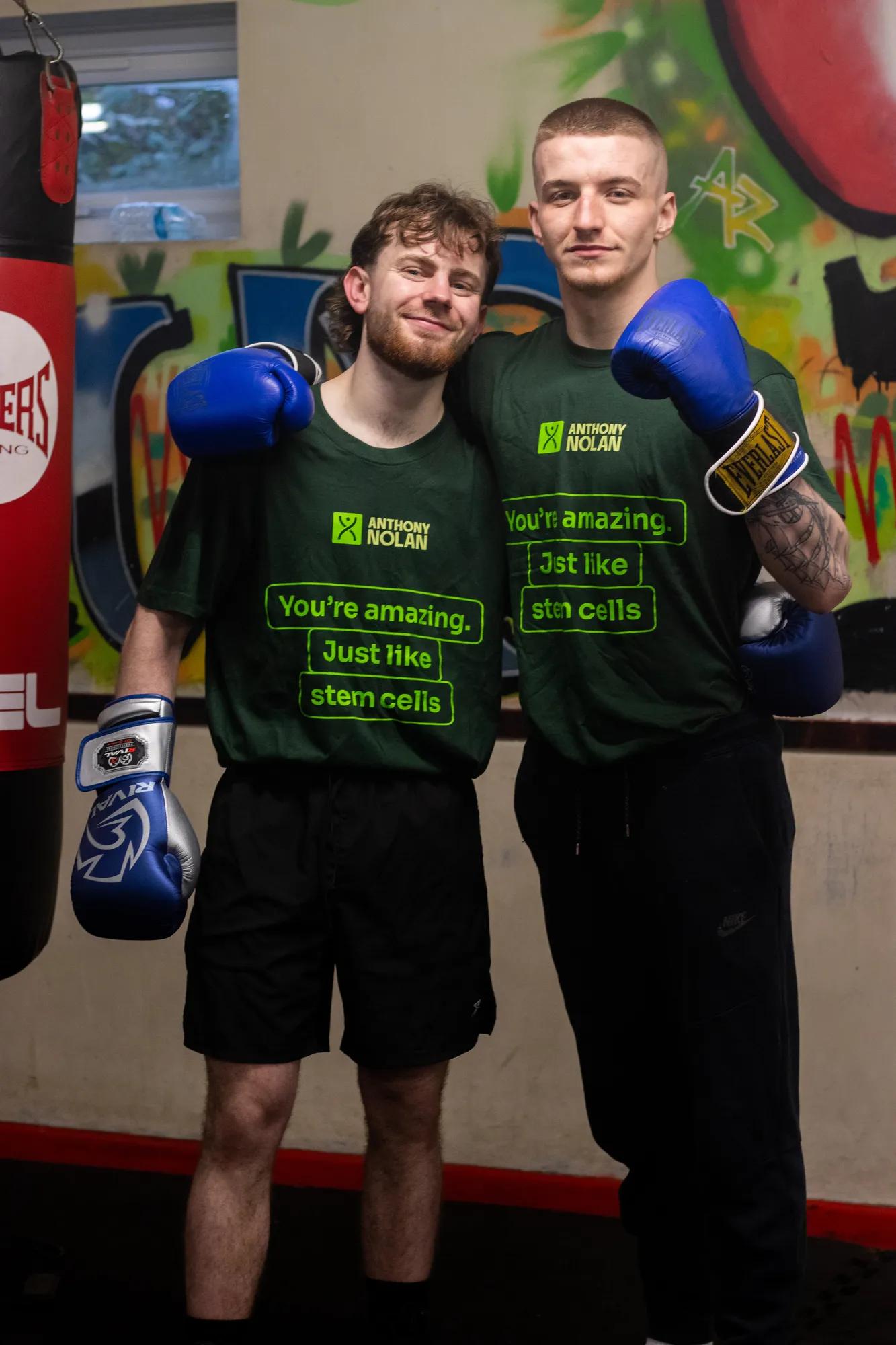 Two young men, named Reuben & Charlie, standing beside each other in a boxing gym, facing the camera