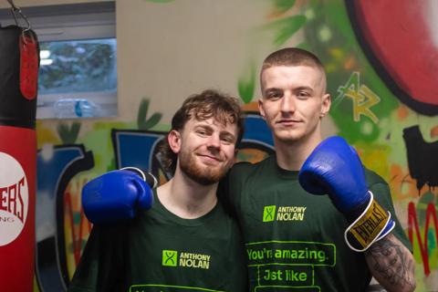 Two young men, named Reuben & Charlie, standing beside each other in a boxing gym, facing the camera