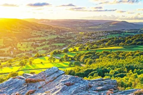 Photo of the Peak District and lots of trees and fields