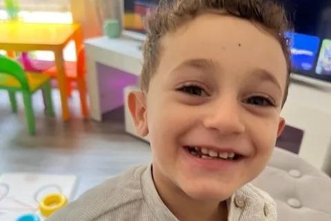 A photo of Mason smiling in the living room