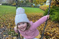 Erin playing on a swing