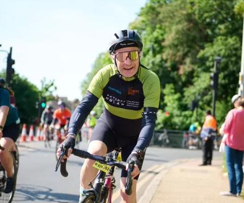 Man riding his bike in his Anthony Nolan cycling jersey for the 2023 RideLondon