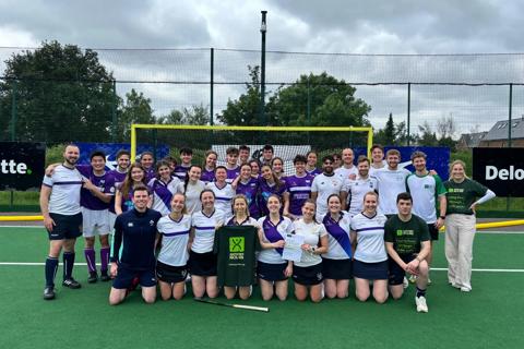 Hockey team holding up AN t-shirt