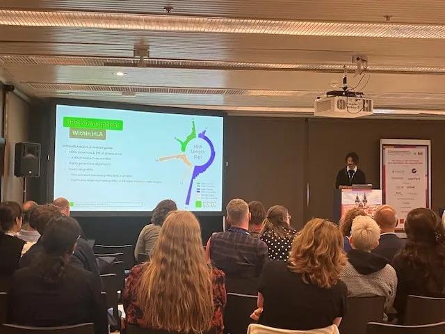 A scientist presenting new research on a projector to a crowd